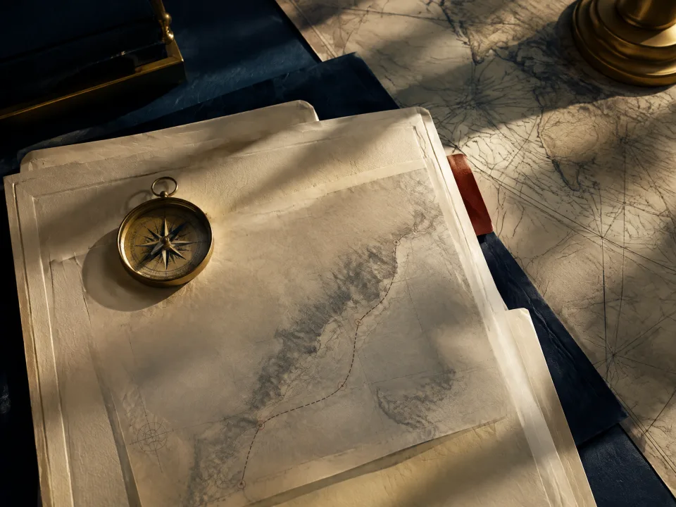 A transaction dossier, compass and map representing an organized evidence record.